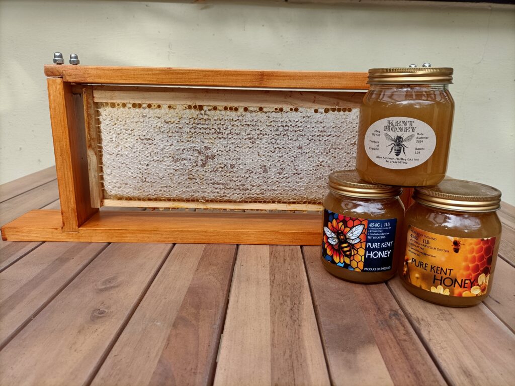 three jars and a frame of honey